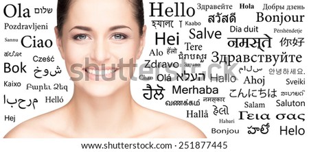Portrait of a woman over the background with a different world languages (language school concept)