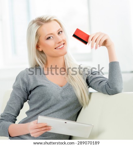 Young and happy woman with a credit card. Online shopping concept.