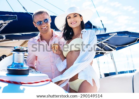 Young, attractive and rich couple have a party on a luxury boat