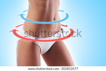 Beautiful girl in swimwear having the cycle arrows around abdomen (healthy eating, vitamins and nutrition concept).