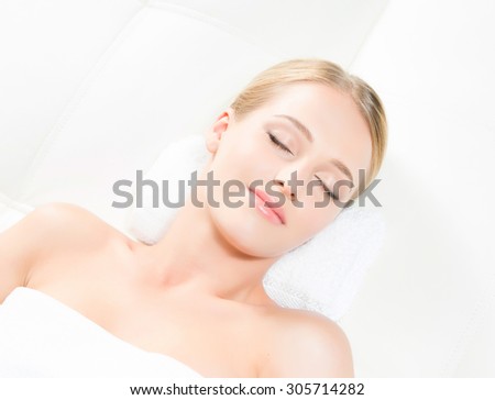 Beautiful laying woman smiling and getting energy from therapy on isolated background.