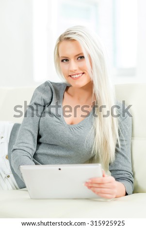 Young and happy woman with a tablet computer