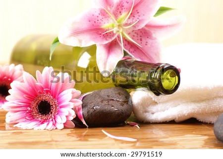 Bottle of massaging oil over spa background