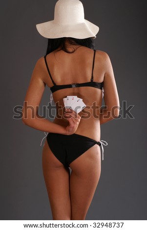 Sexy lady with poker combination over dark background