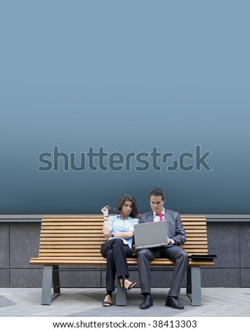 Business couple sitting on the bench