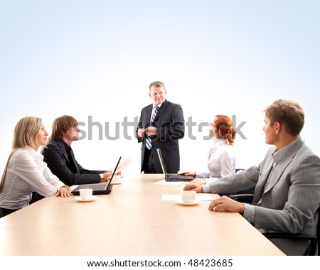 Business group of two young ladies, two young men and a mature boss at work isolated on white