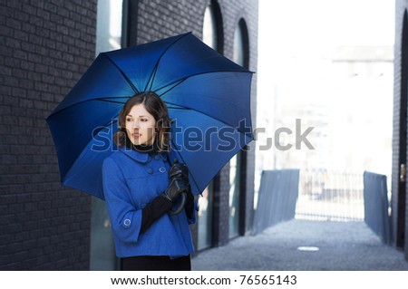 Fashion shoot of young attractive woman with umbrella