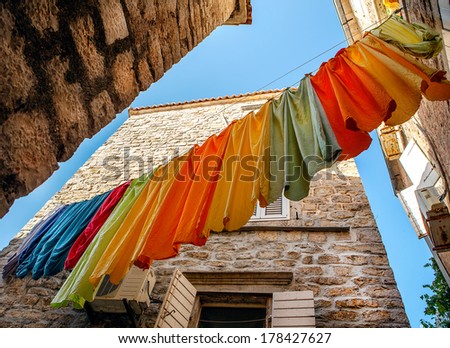 Colorful clothes hanging to dry on a laundry line on Budva street, Montenegro