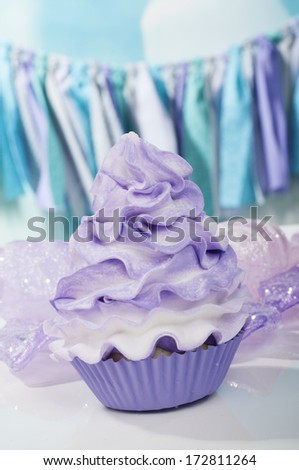 Sweet purple cupcake on bokeh background