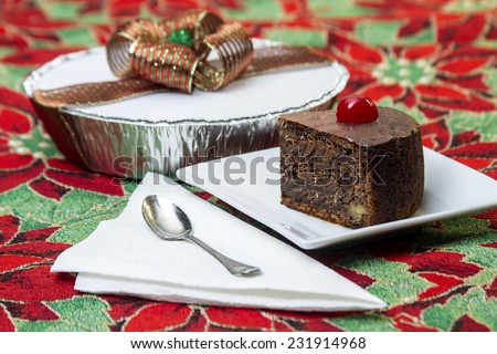 black cake, typical of Latin America regions at Christmas time, and placed on a tablecloth with Christmas decorations