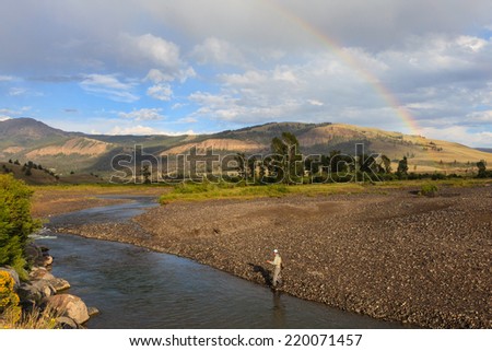 Yellowstone, Wyoming - August 11, 2013: A man fishes in the Yellowstone National Park after a storm
