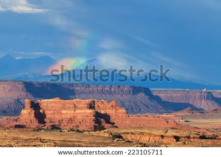 Canyonlands National Park after storm with rainbow and Manti La Sal in the background