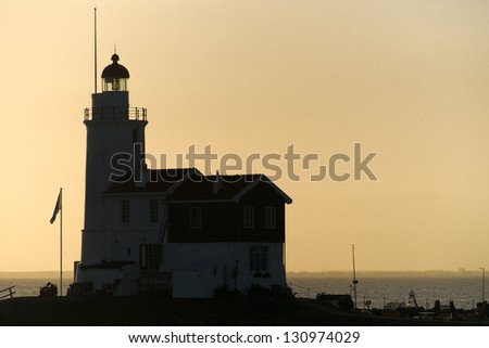 A beautiful beach and lighthouse at sunrise (Marken The Netherlands)