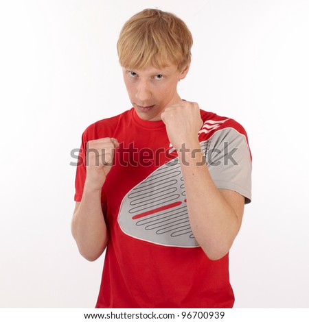The young man in a red t-shirt in a fighting pose