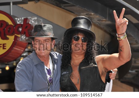 Rock guitarist Slash & actor Charlie Sheen on Hollywood Blvd where he was honored with a star on the Hollywood Walk of Fame. July 10, 2012  Los Angeles, CA Picture: Paul Smith / Featureflash