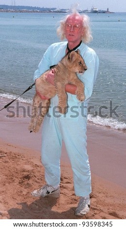 14MAY98: Actor RICHARD HARRIS with lion cub on the beach at the Cannes Film Festival to promote his upcoming movie, 