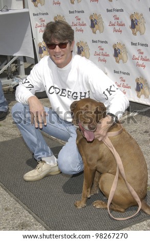 Actor ERIC ROBERTS & dog at the Best Friends Lint Roller Party at Santa Monica Airport, California. The event was held to benefit the Best Friends Animal Sanctuary. march 2003