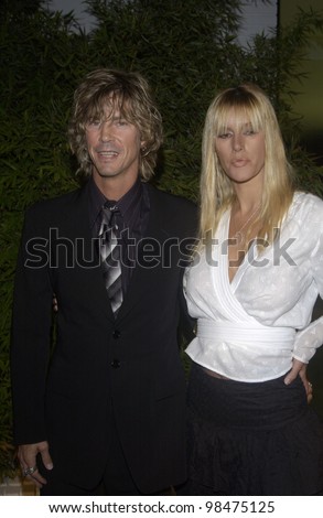 Guns \'n\' Roses star DUFF McKAGAN & wife SUSAN at the opening of designer Stella McCartney\'s first Los Angeles store. Sept 28, 2003  Paul Smith / Featureflash