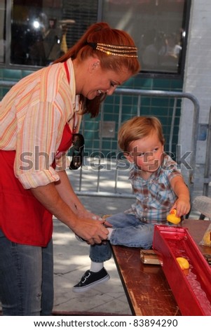 Angie Everhart and son at the Skid Row Block Party at the Los Angeles Mission, Los Angeles, CA. 08-27-11