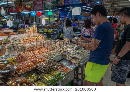 Bangkok, Thailand - May 23, 2015 Unidentified man is buying ready-fresh-sea food at Or Tor Kor markrt, a well known place for fresh food, fruits and foods. Located next to Jatujak market.