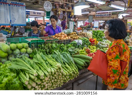 Bangkok, Thailand - May 23, 2015 Unidentified woman is selling fresh vegetable at Or Tor Kor markrt, a well known place for fresh food, fruits and foods. Located next to Jatujak market.