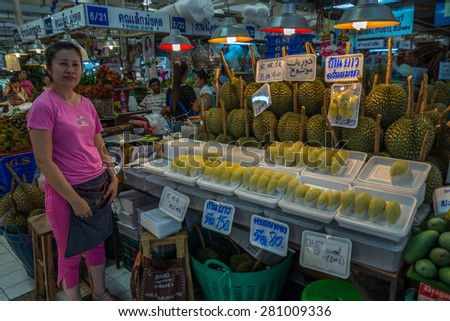 Bangkok, Thailand - May 23, 2015 Unidentified woman is selling durian at Or Tor Kor markrt, a well known place for fresh food, fruits and foods. Located next to Jatujak market.