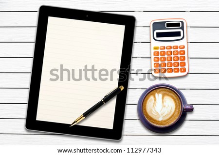Touch screen device and stationery with cup of coffee on  white wood panel background