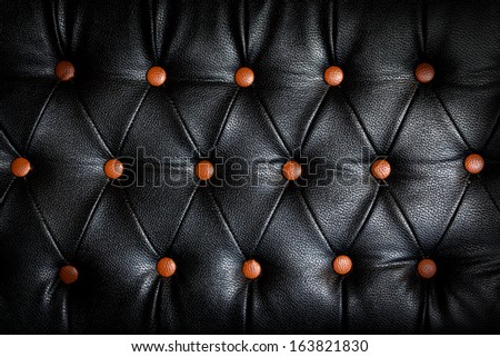 abstract black Leather against orange dot background