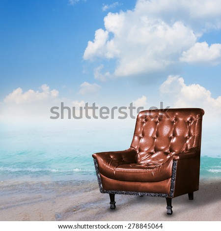 Summer concept. Leather sofa on the beach.