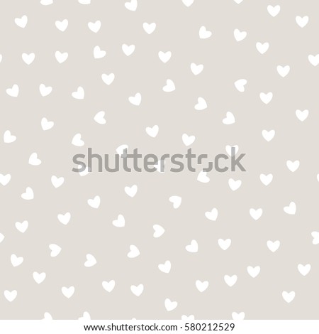 Vector seamless pattern. Inspired by Memphis Design. Trendy texture with a jumble of hearts. Abstract background with love theme.