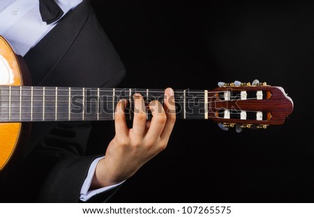 Playing the guitar. Musical instrument with performer hands