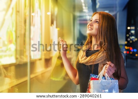 Smiling young woman shopping at an outdoor mall