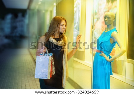Beautiful young woman shopping at an outdoor mall
