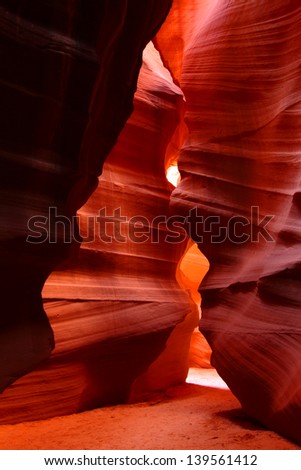 Patches of light illuminate the beautifully colored rock walls of Antelope Canyon in Arizona
