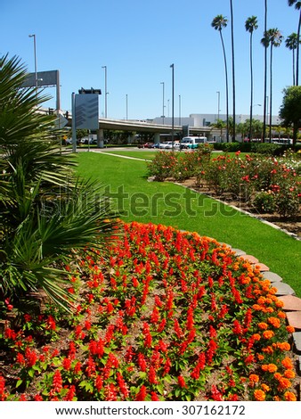 LOS ANGELES, USA - JUNE 27, 2005: Flower gardens and palm trees create a scenic landscape outside the Los Angeles International Airport in California.