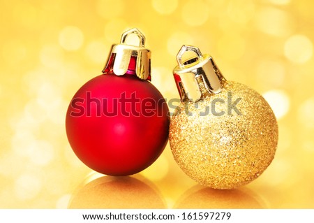 Close up of Christmas balls on gold sparkle background. Christmas decorations on gold background.