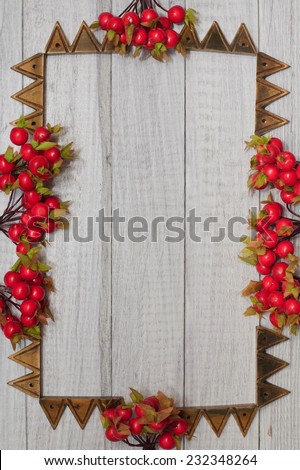 Christmas frame with red berries  and golden ornaments