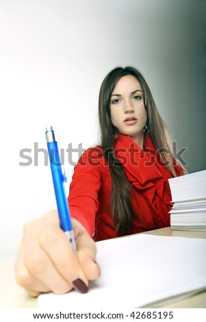 Half body portrait of attractive businesswoman or secretary with pen and pile of papers, graduated light background.