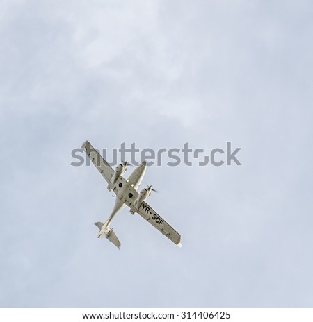 BUCHAREST, ROMANIA - SEPTEMBER 5, 2015. Aerobatic airplane pilots training in the sky of the city. Diamond airplane.
