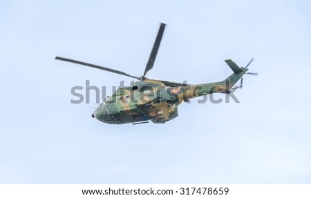 BUCHAREST, ROMANIA - SEPTEMBER 5, 2015. Aerobatic elicopter pilots training in the sky of the city. Puma elicopter, navy, army drill.