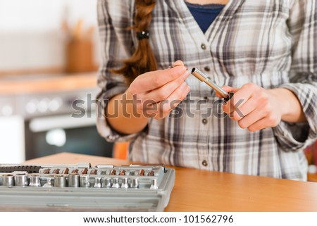 Woman with toolbox and screwdriver - only torso to be seen