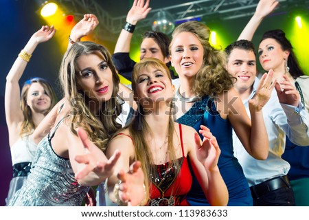Young People Dancing In Club Or Disco And Have Party; The Girls And ...
