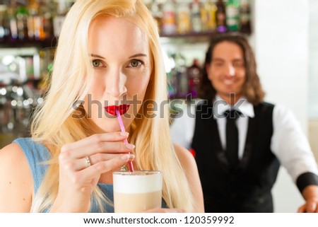 Coffeeshop - barista in cafe with a female attractive client, she is drinking coffee