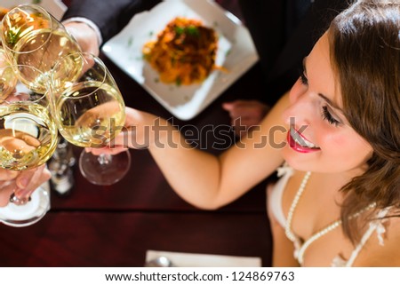 Good friends for dinner or lunch in a fine restaurant, clinking glasses