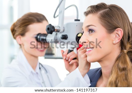 Doctor - Young female doctor or ENT specialist - with a patient in her practice, examining the ear with a endoscope