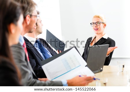 Business - businesspeople have a meeting with presentation in office, they negotiate a contract