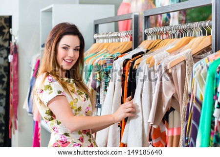 Young woman having fun while fashion shopping in boutique or store