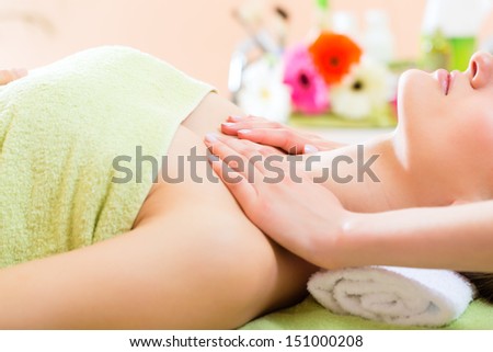 Wellness - woman receiving neck or shoulder massage in spa