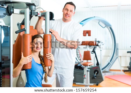 Patient at the physiotherapy making physical exercises with her therapist