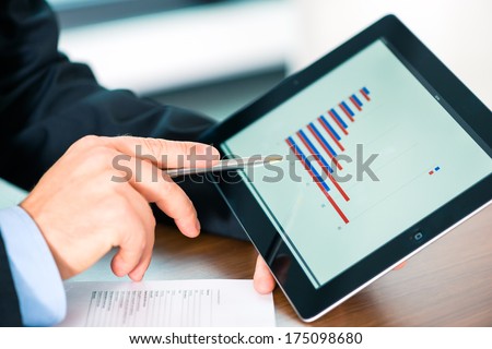 Business - banker, Manager or expert evaluates the figures on tablet computer and compares the development of the business in real time to quickly and efficient advise and act as consultant
